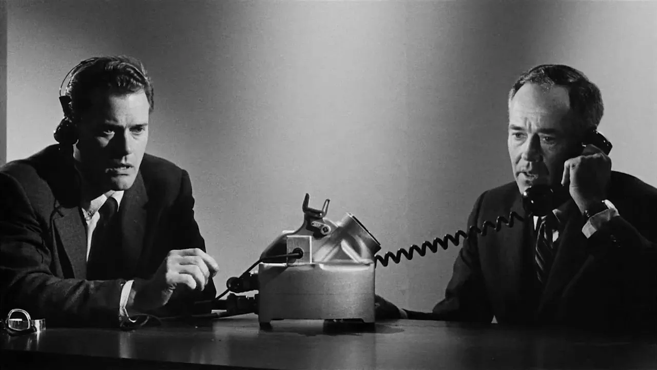 A shot from the movie fail-safe showing two men talking on the phone. The photo is in black and white.