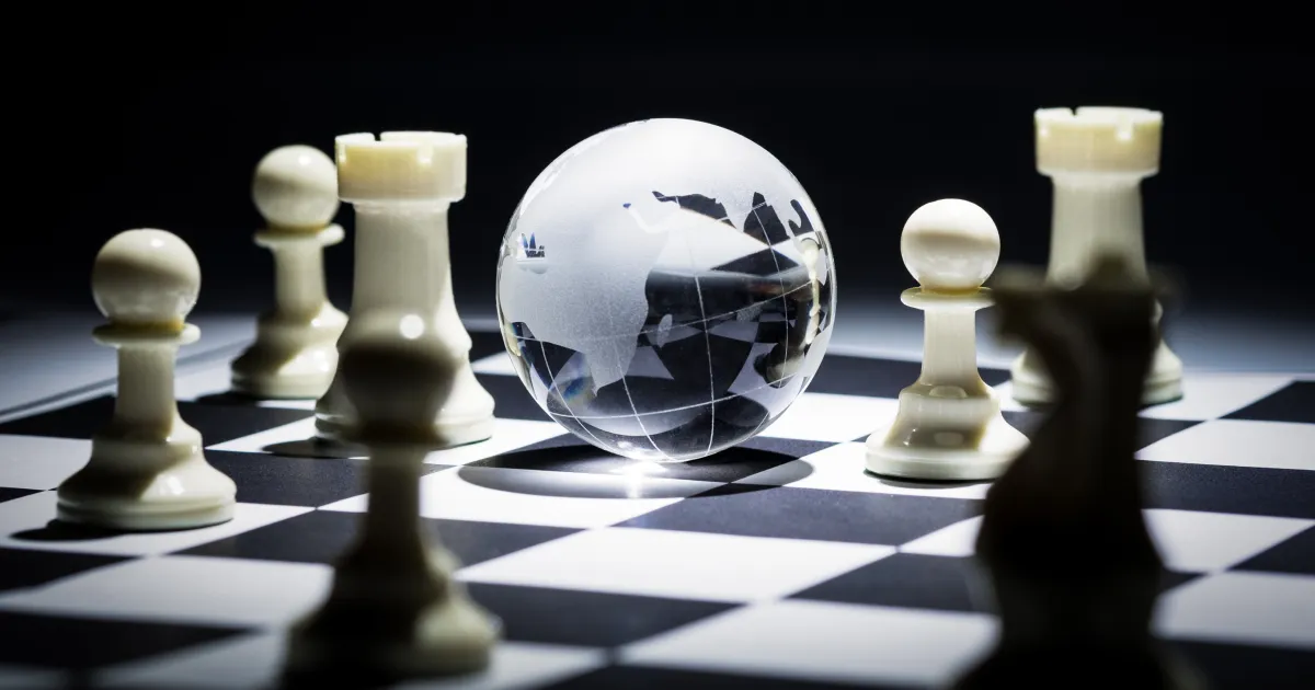 An image showing a chessboard with a globe in the middle representing geopolitics, one of the 5 supply chain megatrends of 2024.